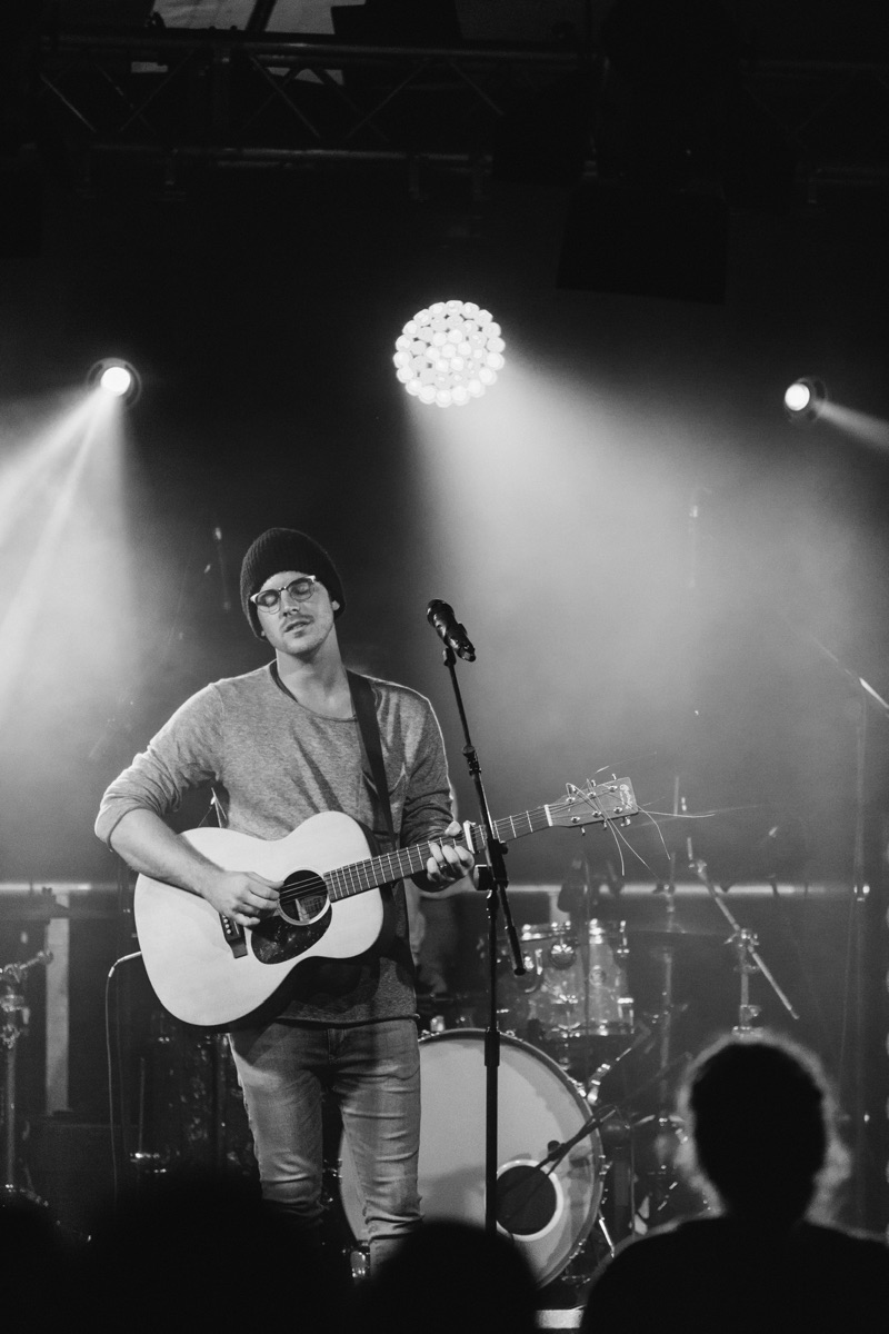 Brock Human on stage with a guitar