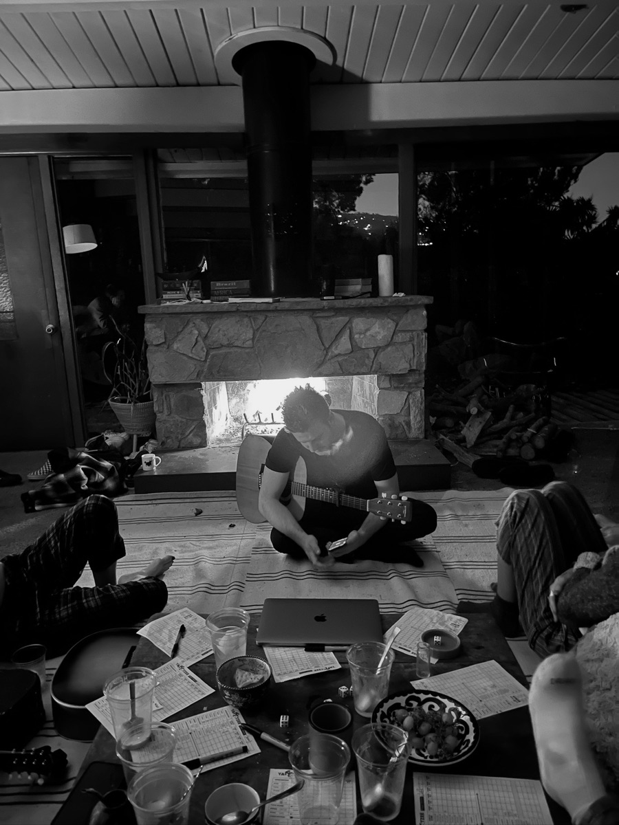 Friends gathered around a fireplace